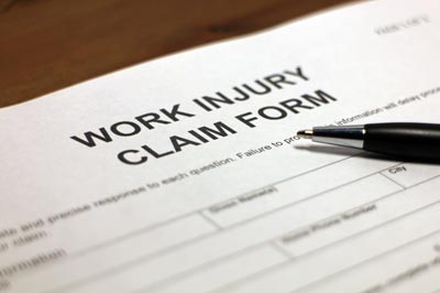 Closeup of a paper that reads "work injury claim form"