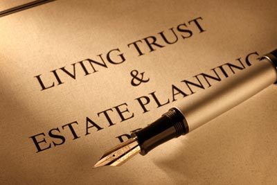 A paper with a pen on top that read "living trust & estate planning"